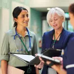 Interim Nursing Home Administrator talking with 2 other females in clinical setting