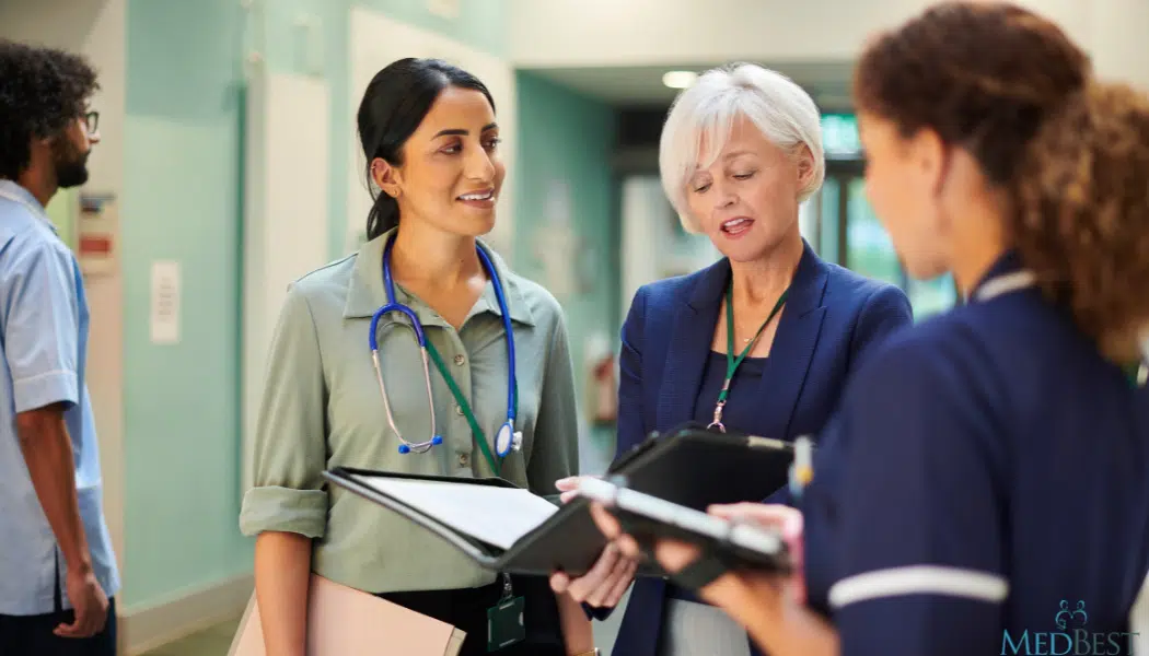 Interim Nursing Home Administrator talking with 2 other females in clinical setting