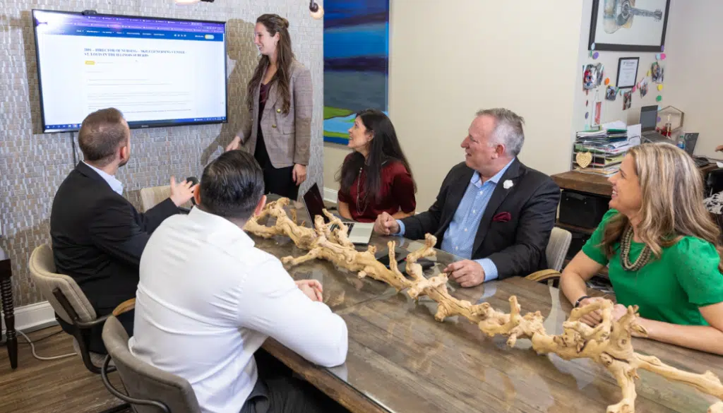 Senior Care Executives meeting around a table to discuss an onboarding plan