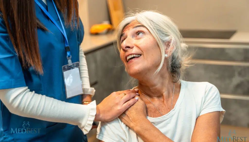 Female Wellness Director reassuring elderly resident at senior care community
