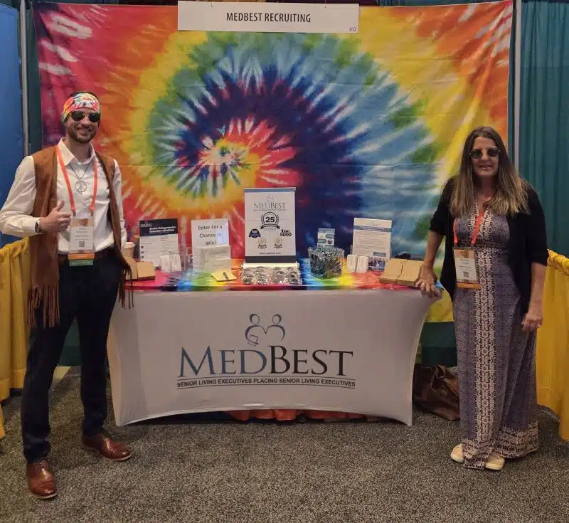 MedBest Team exhibiting at a conference with 70's theme