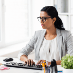 Women in suit at desk in office serving as interim Assisted Living Administrator