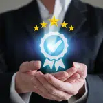 Man in suit holding image that depicts the gold standard